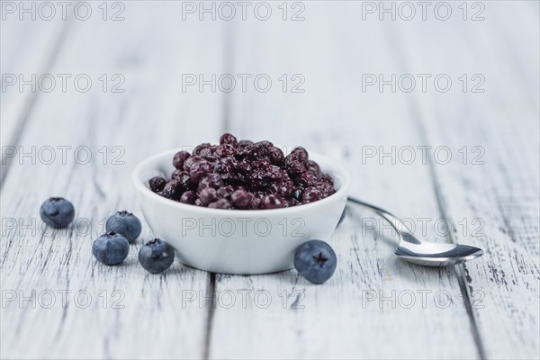 Homemade Preserved Blueberries on an wooden table as detailed close-up shot, selective focus