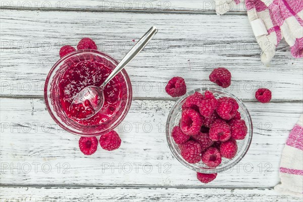 Fresh made Raspberry Jam on an old and rustic wooden table, selective focus, close-up shot