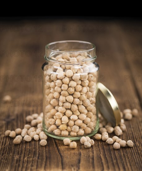Chickpeas on a vintage background as detailed close-up shot, selective focus