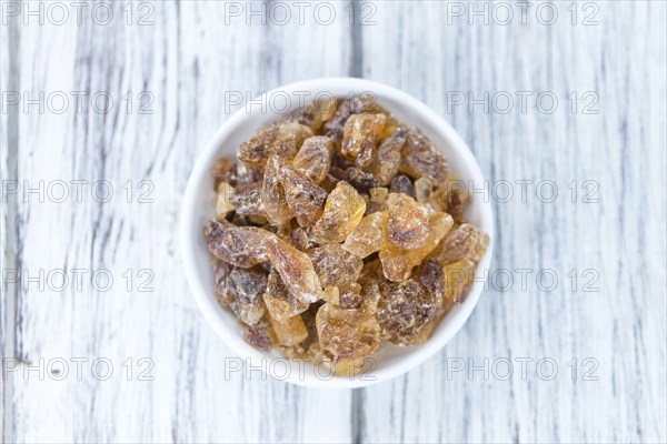 Brown Rock Candy on wooden background (selective focus, close-up shot)