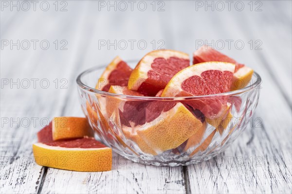 Grapefruits slices (selective focus) on a vintage background as detailed close-up shot