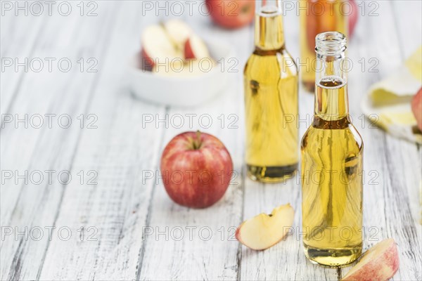 Fresh made Apple Cider on a vintage background (close-up shot)