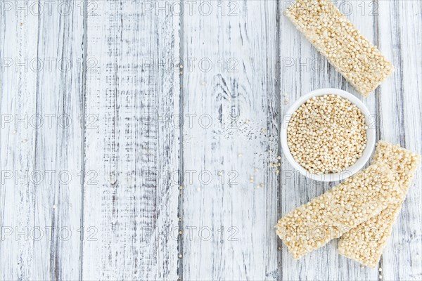 Fresh made Quinoa Bars (selective focus, close-up shot) on an old wooden table