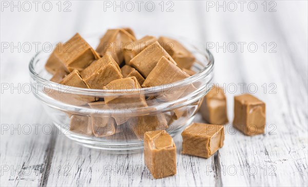 Caramel on a vintage background as detailed close-up shot (selective focus)