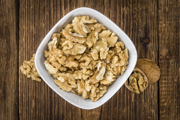 Walnut kernels on a vintage background as detailed close-up shot (selective focus)