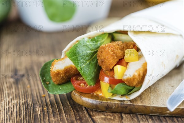Fresh made Chicken Wraps on an vintage background (selective focus)