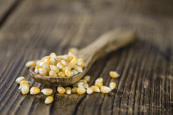 Wooden table with a portion of Corn (selective focus, close-up shot)