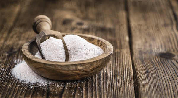 Pink Himalayan Salt on rustic wooden background (close-up shot)