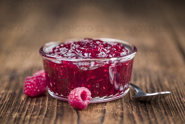 Fresh made Raspberry Jam on a vintage background as detailed close-up shot