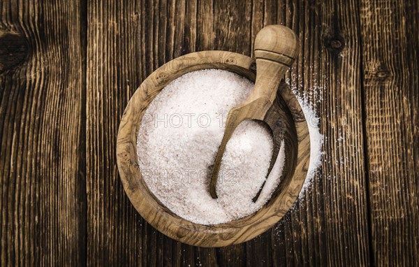 Himalayan Salt as high detailed close-up shot on a vintage wooden table (selective focus)
