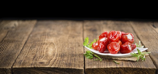 Fresh made Red Pepper (stuffed with cheese) on an old and rustic wooden table (selective focus,