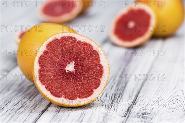 Grapefruits slices (selective focus) on a vintage background as detailed close-up shot