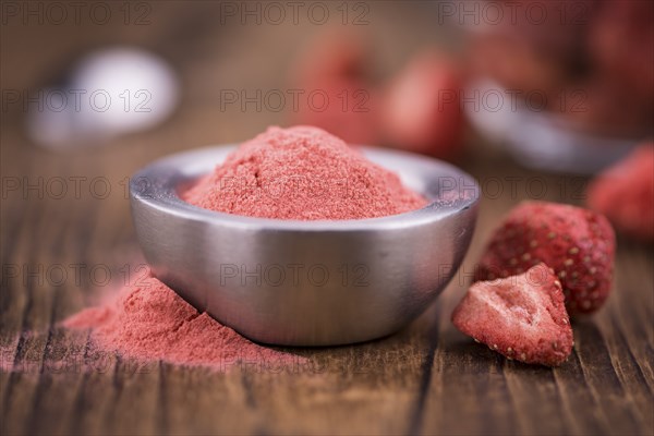 Fresh made Strawberry powder on a vintage background as detailed close-up shot