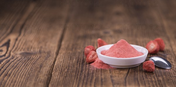 Fresh made Strawberry powder on a vintage background as detailed close-up shot