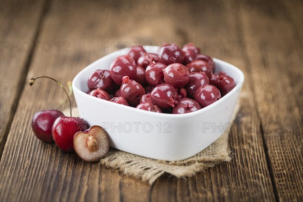 Preserved Cherries on a vintage background as detailed close-up shot, selective focus