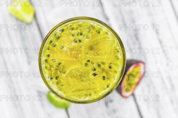 Vintage wooden table with Jorge Amado Cocktail (selective focus, close-up shot)