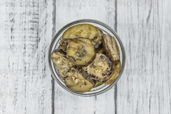 Fresh made Zucchinis (grilled) on an old and rustic wooden table (selective focus, close-up shot)
