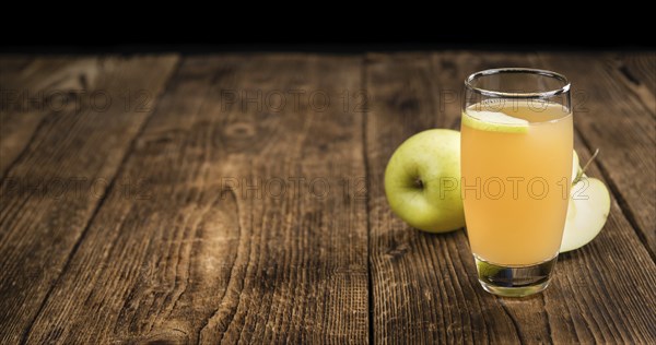 Apple Juice on a vintage background as detailed close-up shot (selective focus)