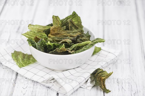 Vintage wooden table with Savoy Chips (selective focus, close-up shot)