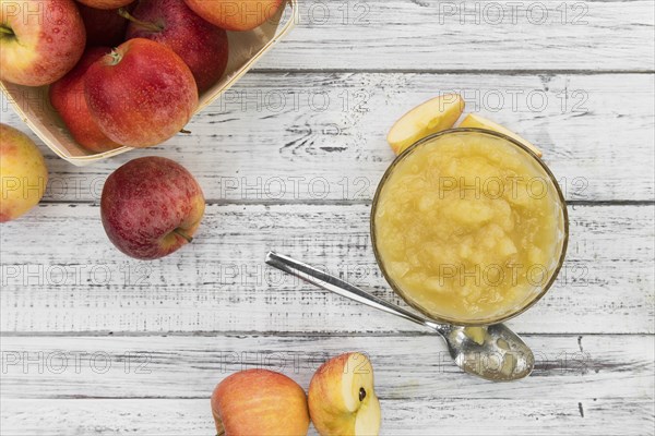 Homemade Applesauce (selective focus, close-up shot) on vintage background with some fresh fruits