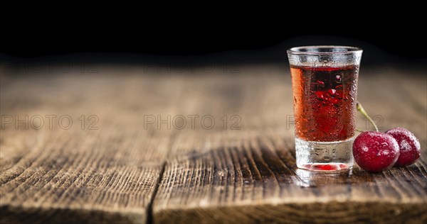 Some homemade Cherry Liqueur as detailed close-up shot, selective focus