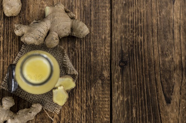 Portion of healthy Ginger Drink (selective focus, close-up shot)