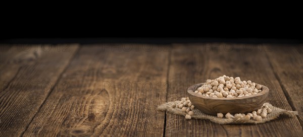 Chickpeas on a vintage background as detailed close-up shot, selective focus