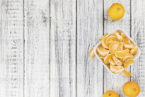 Raw Tangerine pieces (close-up shot) on vintage background