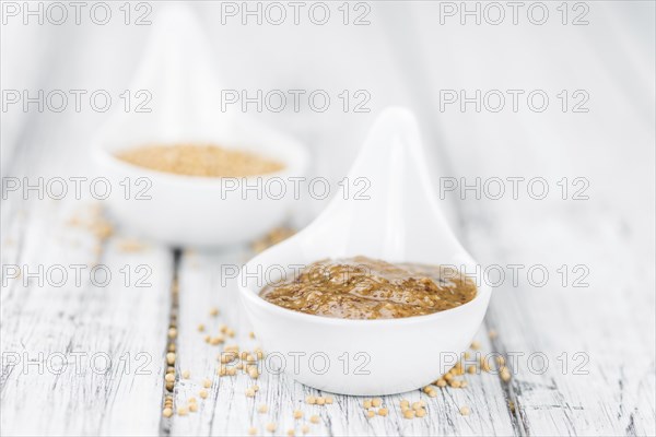 Fresh made German Cuisine (sweet Mustard) on a vintage background (close-up shot)
