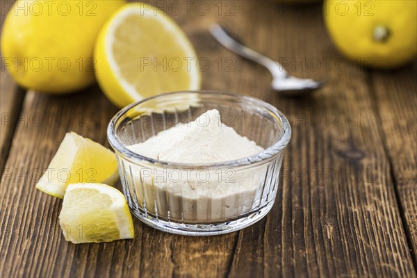 Wooden table with Lemon powder (detailed close-up shot, selective focus)