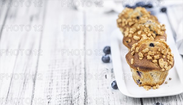 Some fresh Blueberry Muffins (selective focus, close-up shot)