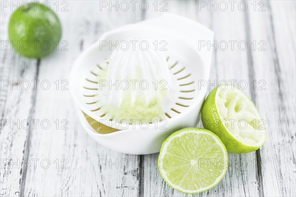 Lime Juice on a vintage background as detailed close-up shot (selective focus)