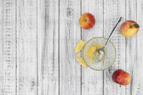 Portion of homemade Applesauce (selective focus, close-up shot) on vintage background