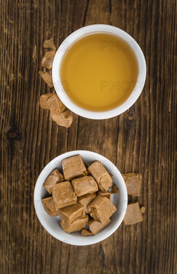 Caramel Sirup on a vintage background as detailed close-up shot (selective focus)