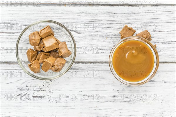 Caramel Sauce on a vintage background as detailed close-up shot (selective focus)