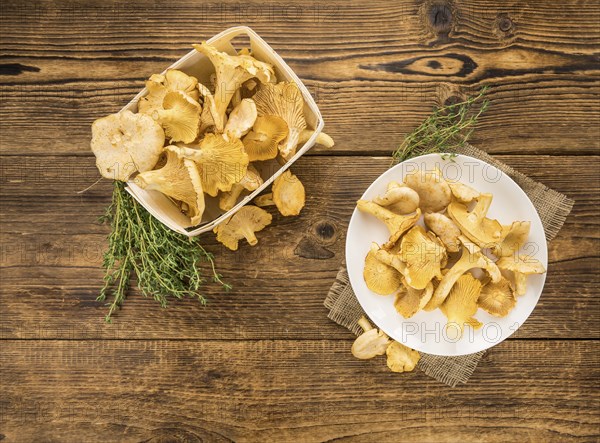 Fresh harvested Chanterelles (on a wooden table) as detailed close-up shot