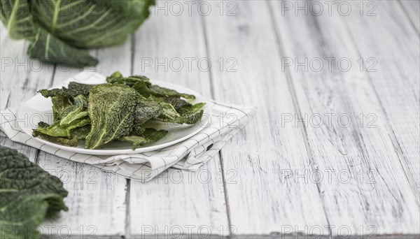 Vintage wooden table with Savoy Chips (selective focus, close-up shot)
