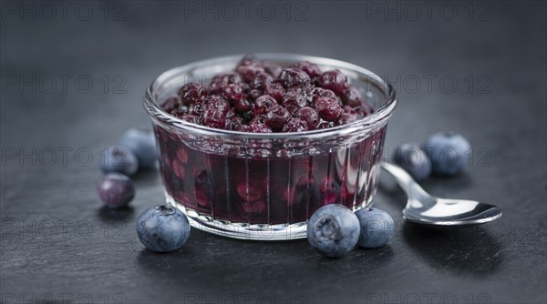 Some fresh Preserved Blueberries on a vintage slate slab, selective focus, close-up shot