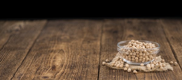 Chickpeas on an old wooden table as detailed close-up shot, selective focus