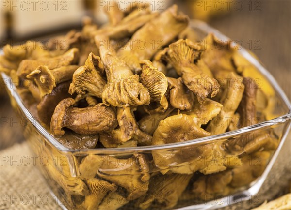 Canned chanterelles on a vintage background as detailed close-up shot, selective focus