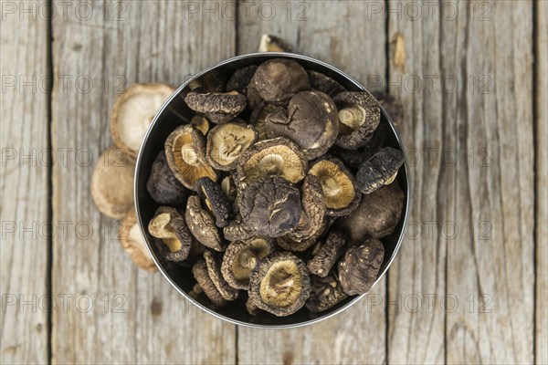 Dried Shiitake on a vintage background as detailed close-up shot, selective focus