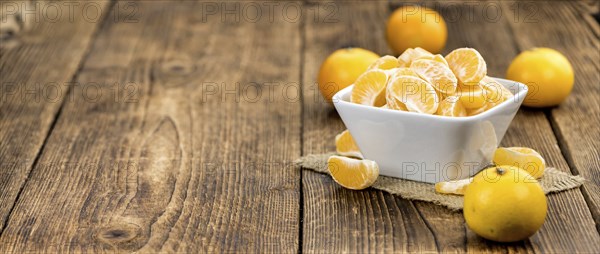 Raw Tangerine pieces (close-up shot) on vintage background