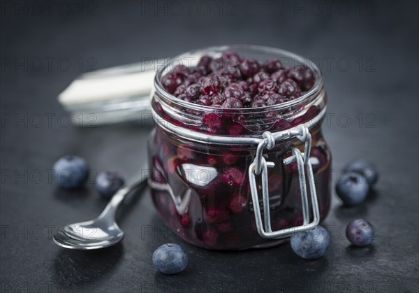 Preserved Blueberries on a vintage background as detailed close-up shot, selective focus