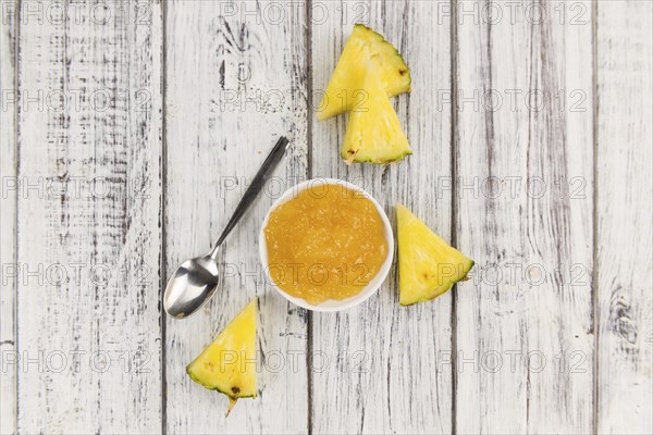 Fresh made Pineapple Jam on an old and rustic wooden table, selective focus, close-up shot