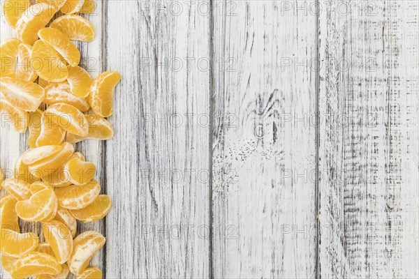 Fresh Tangerine pieces (selective focus) on a vintage background