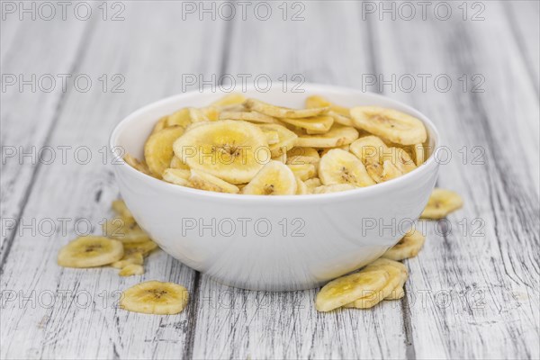 Portion of fresh Dried Banana Chips close-up shot, selective focus