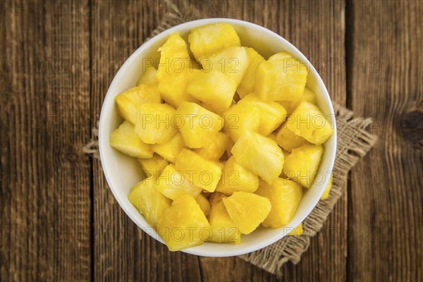 Fresh made Pineapple (sliced) on a vintage background as detailed close-up shot