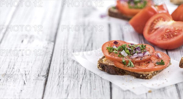 Portion of healthy Tomato Sandwich on an old wooden table (selective focus, close-up shot)