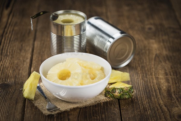 Preserved Pineapple Rings on a vintage background as detailed close-up shot, selective focus