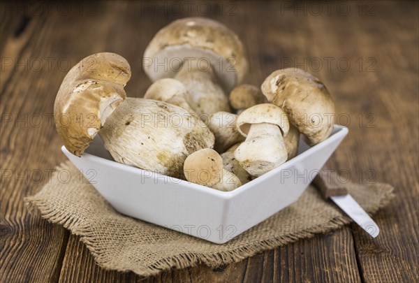 Fresh Porcinis (raw) on a vintage background as detailed close-up shot (selective focus)
